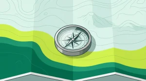 Grüner Kompass auf einer gefalteten Karte mit geometrischen Wegen